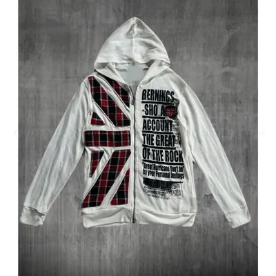 A cream hoodie with a printed slogan running across the chest