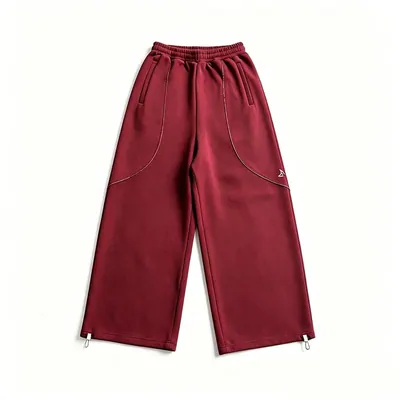 A pair of dark red wide-leg track trousers